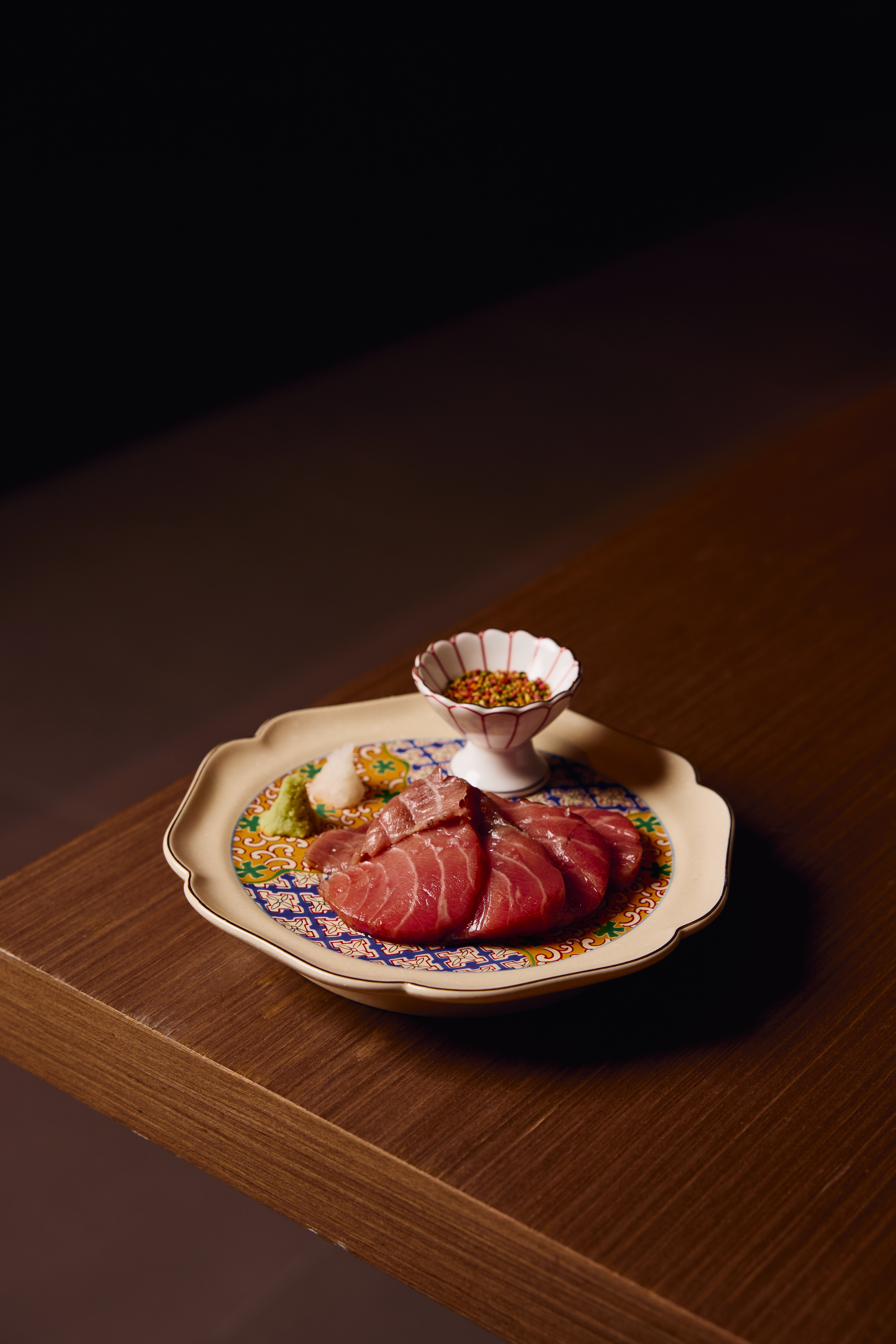 a plate of food sitting on top of a wooden table