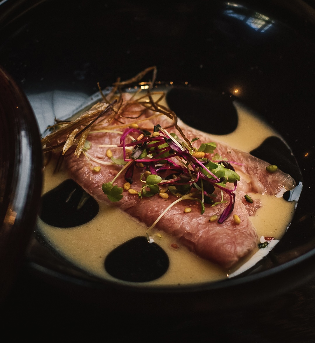 a slice of pizza sitting on top of a car