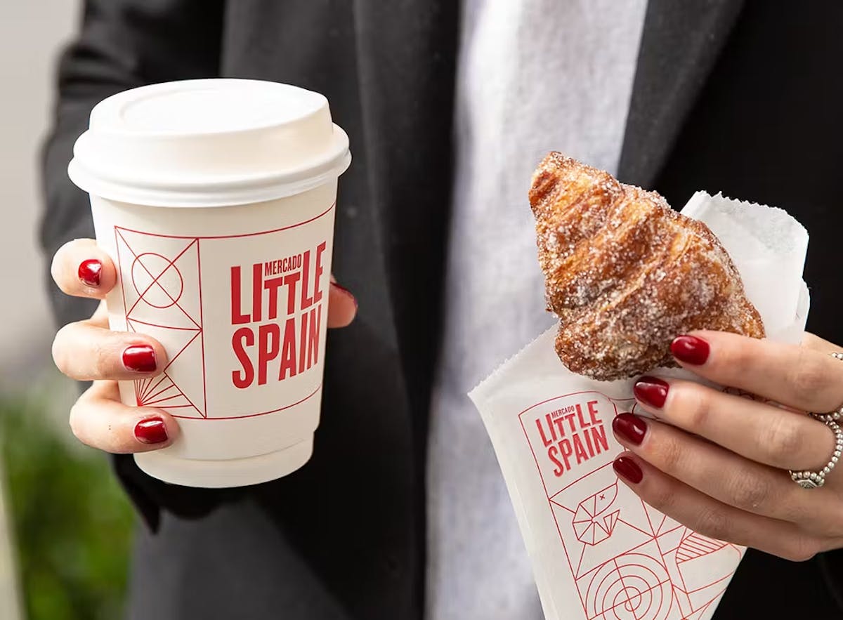 a person holding a cup of coffee