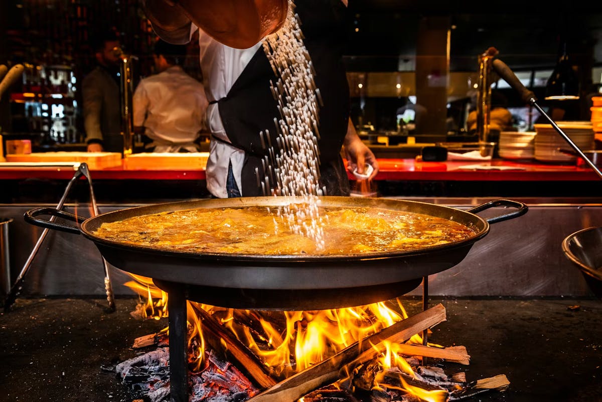 a close up of a person cooking food on a table