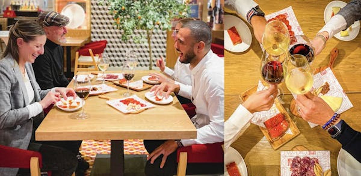 a group of people sitting at a table eating food