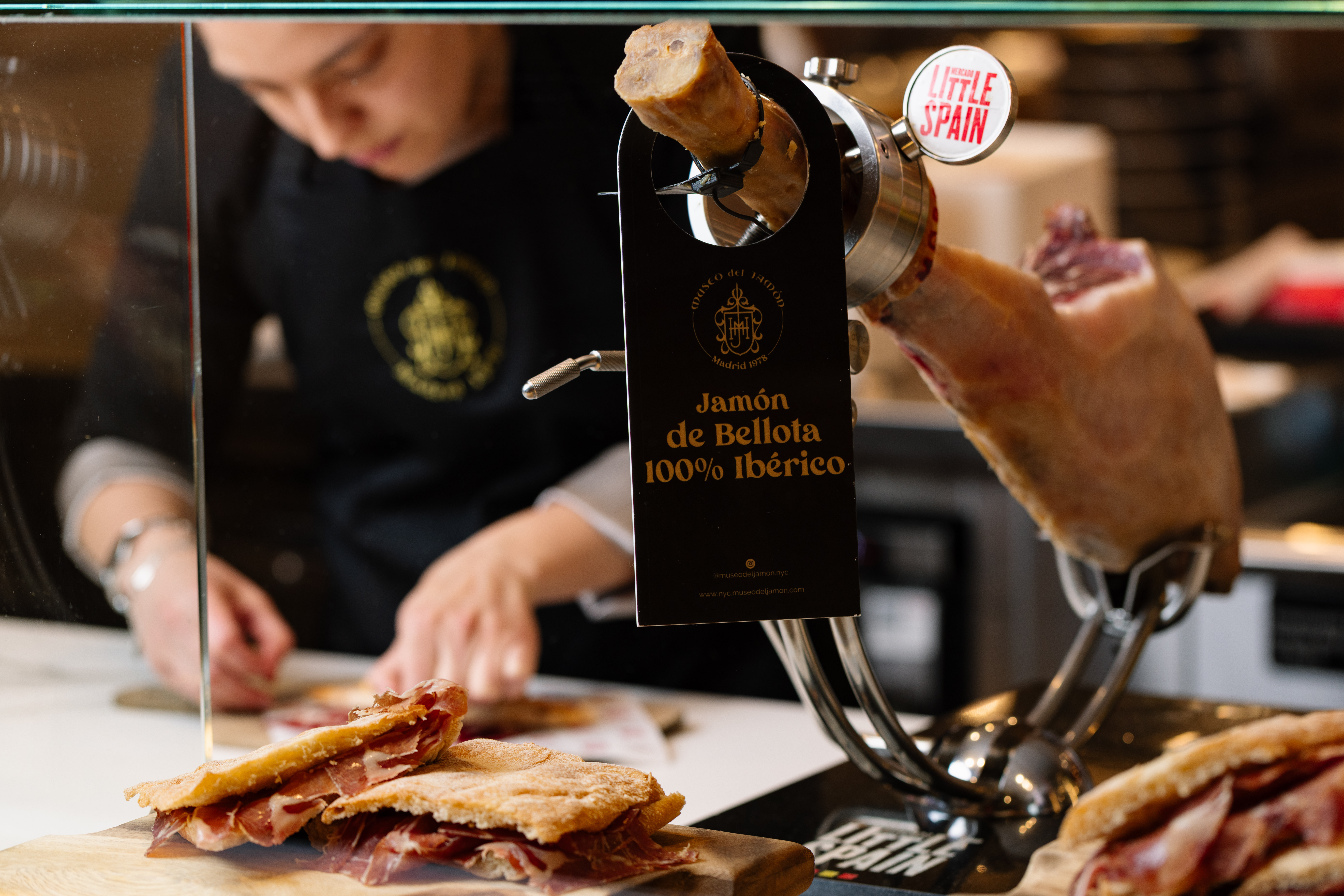 a person cutting meat in a butchery