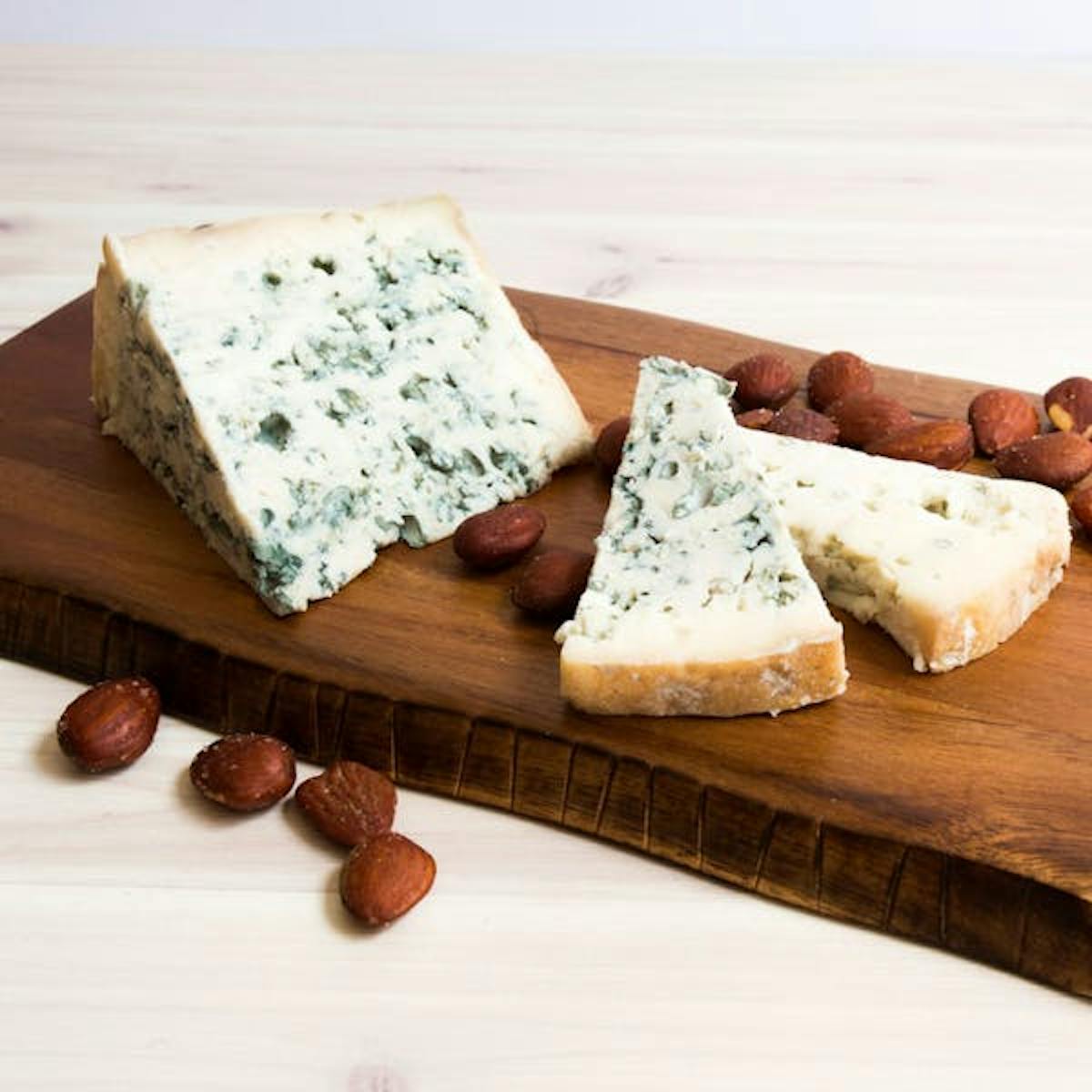 a piece of bread on a wooden cutting board