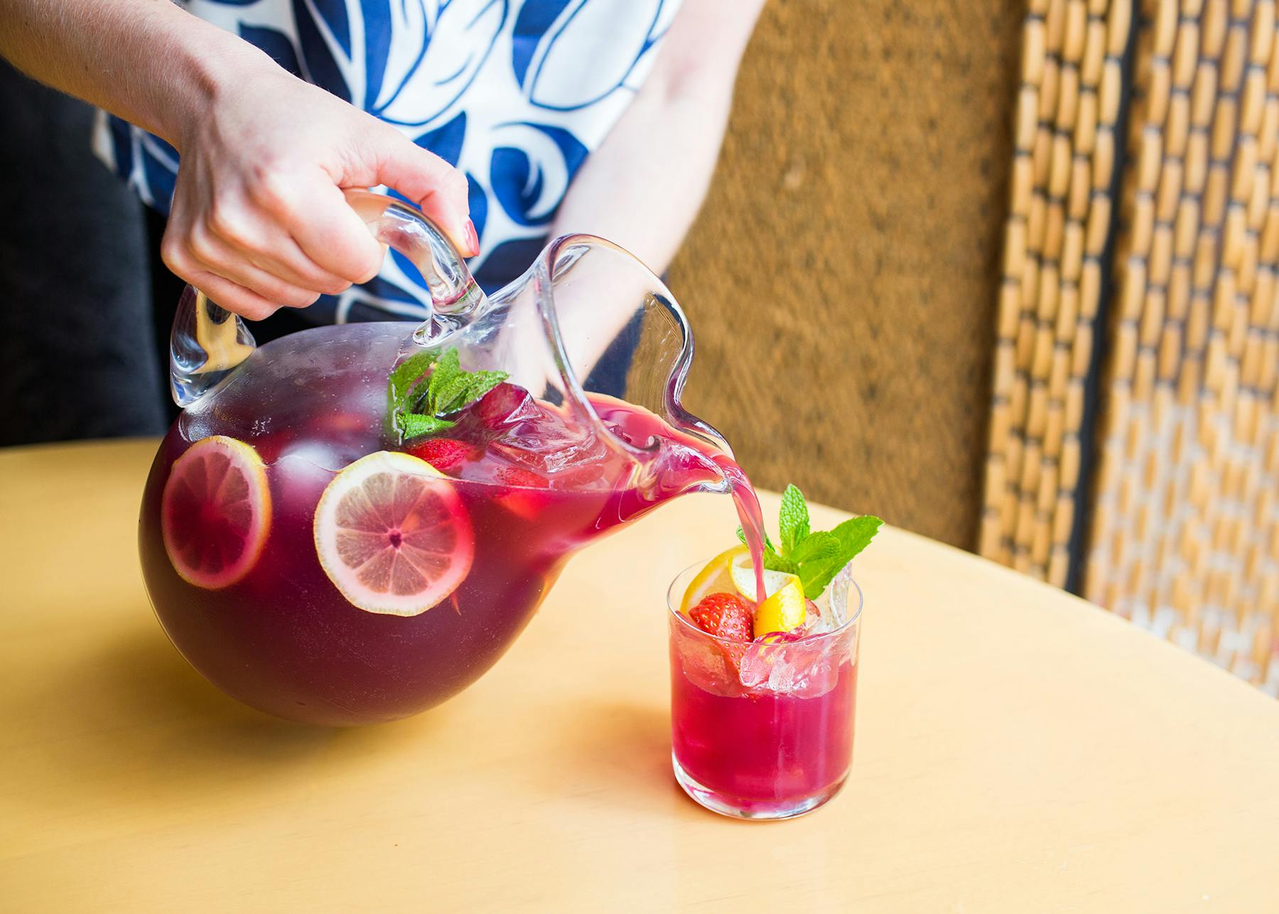 a person sitting at a table with a bowl of fruit