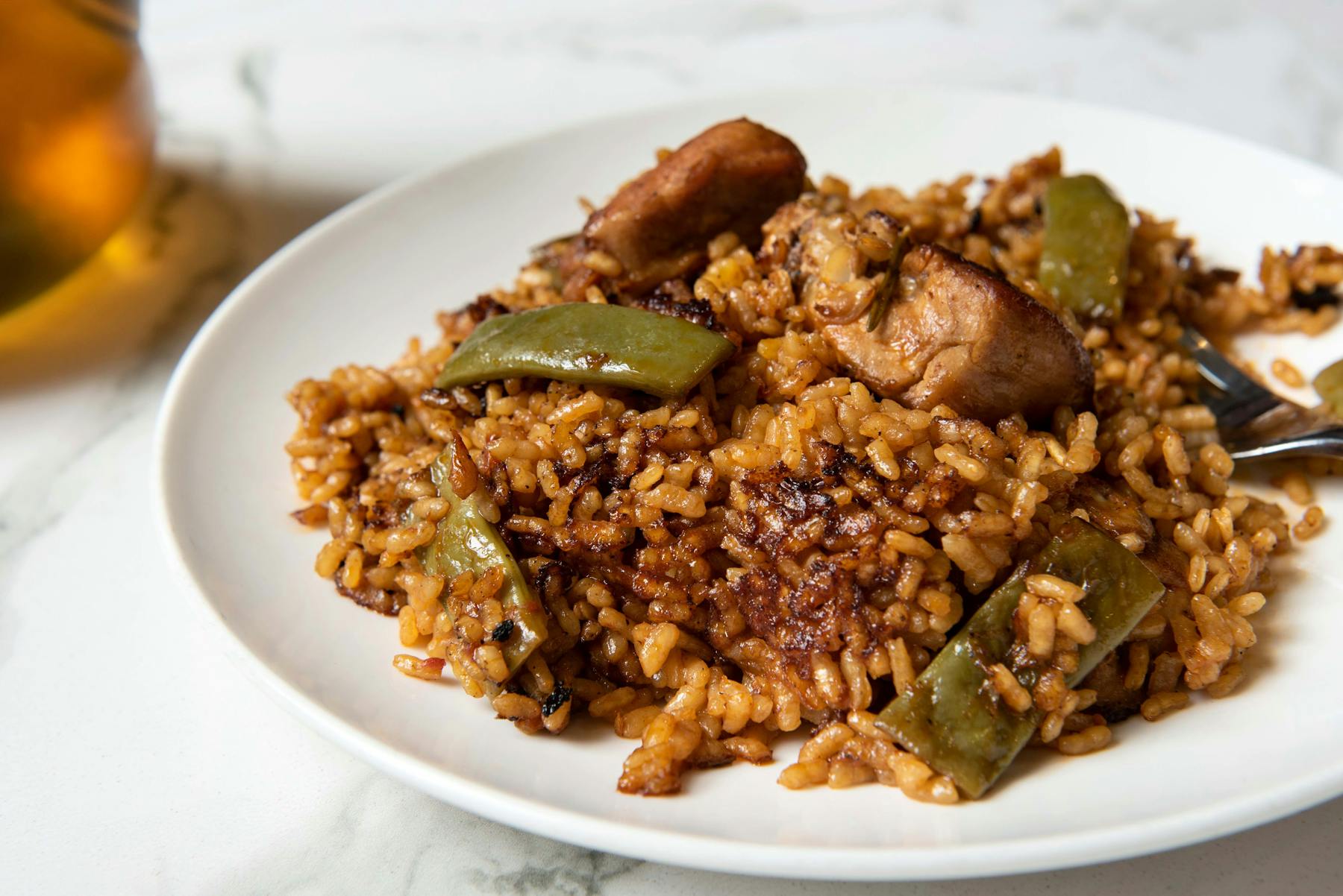 a plate of food with rice meat and vegetables