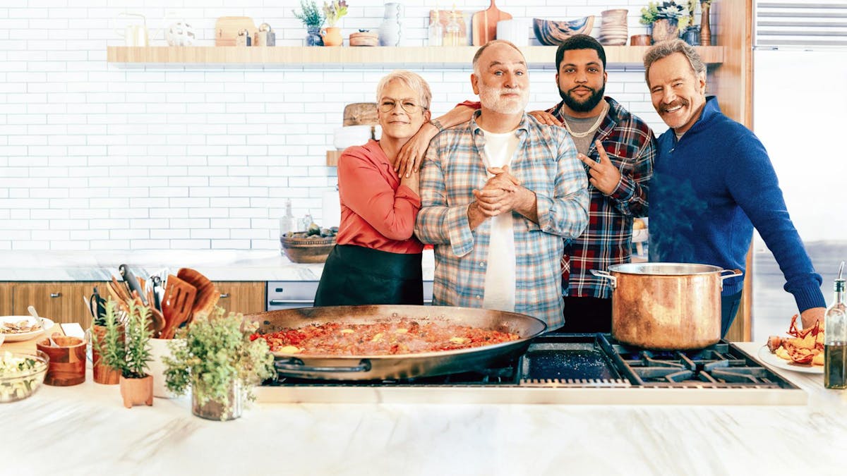 Jose Andres, O'Shea Jackson Jr., Bryan Cranston standing around a table with a plate of food