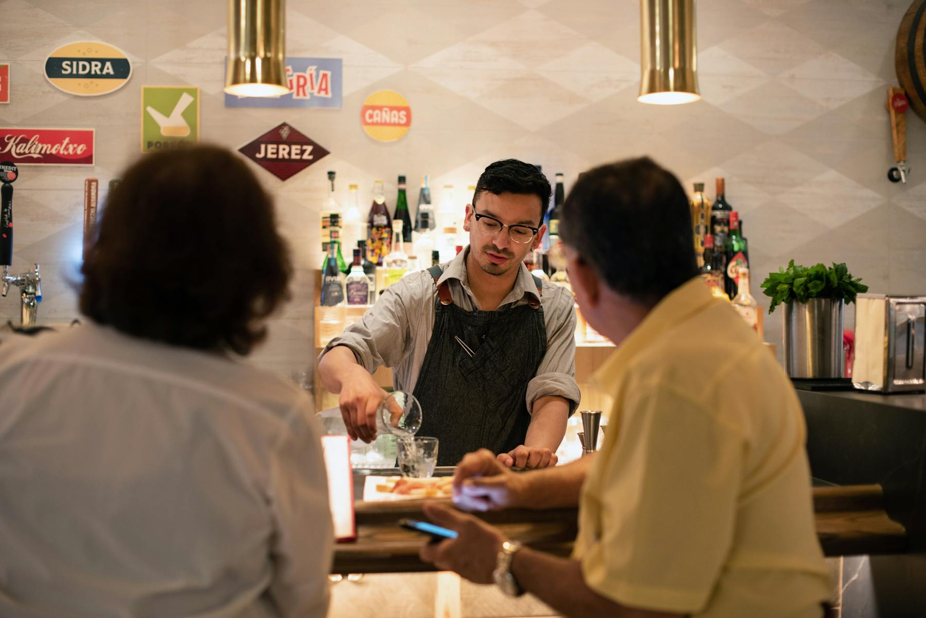 a group of people preparing food in a kitchen