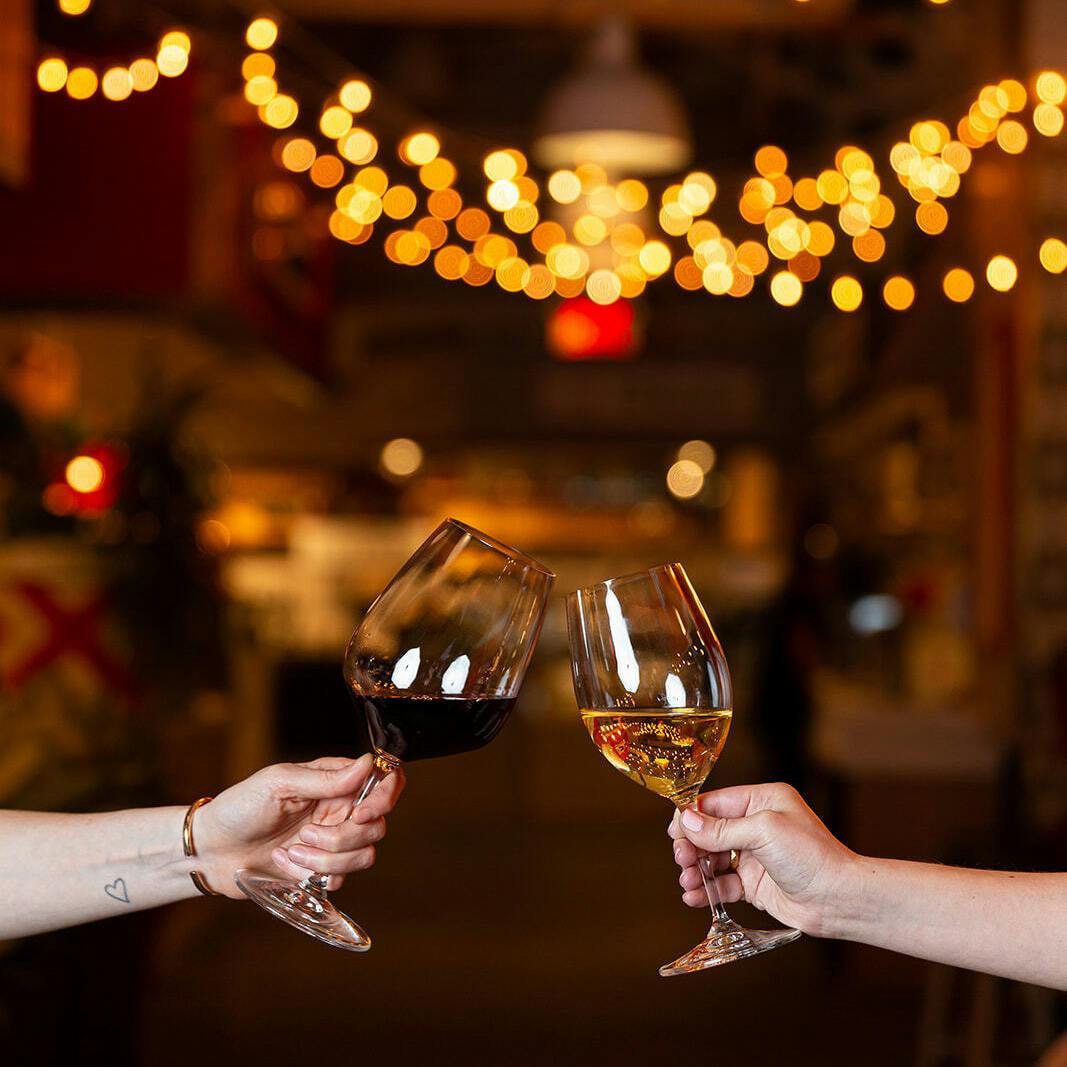 2 people holding wine glasses