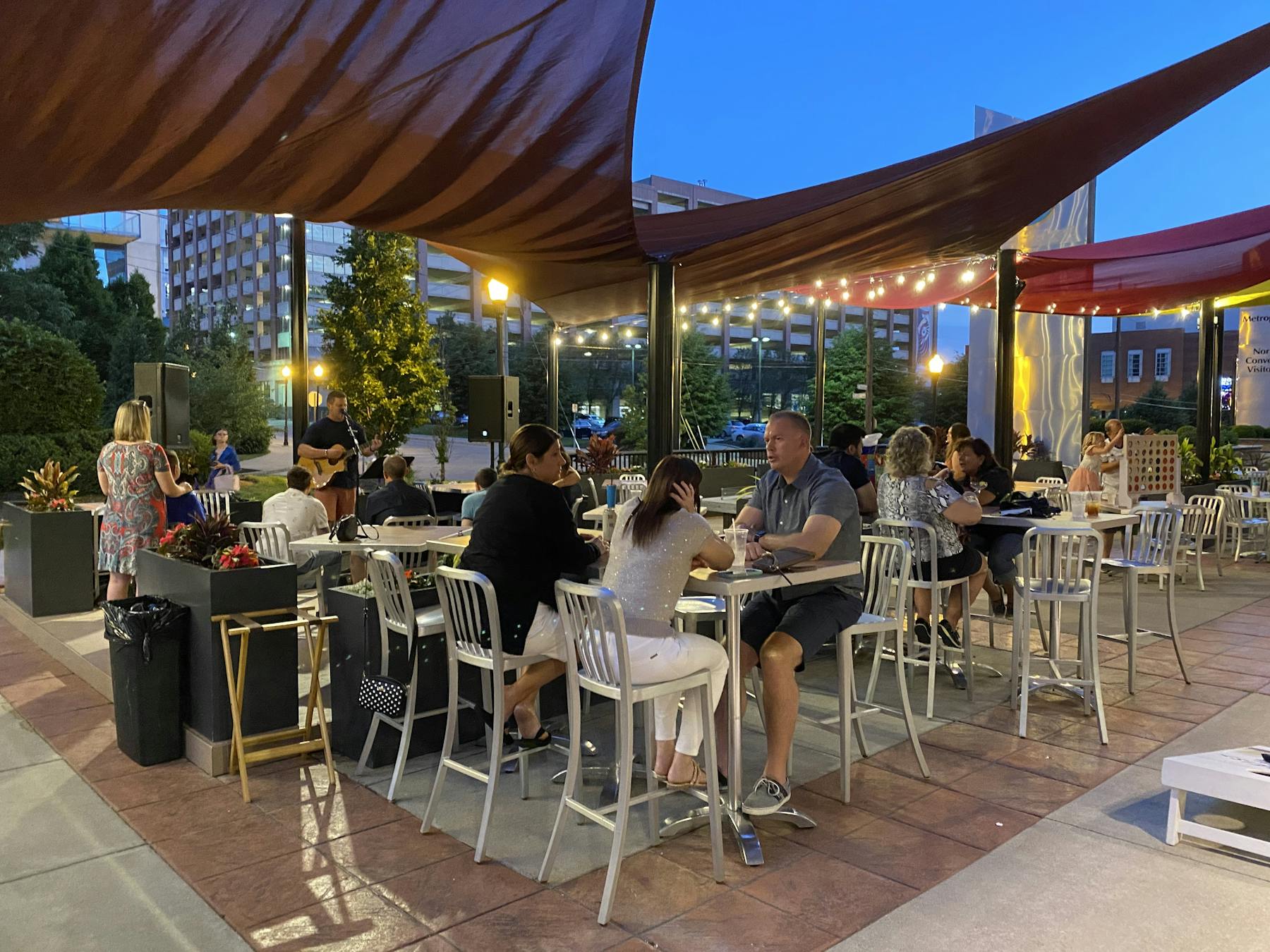 a group of people sitting at a table in front of a building