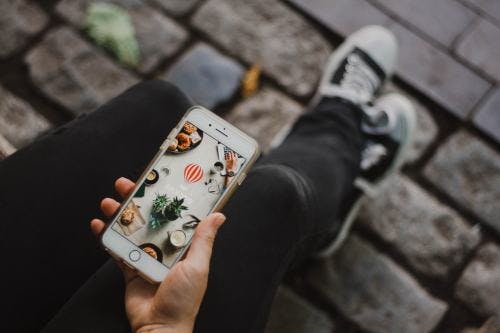 a hand holding a cell phone