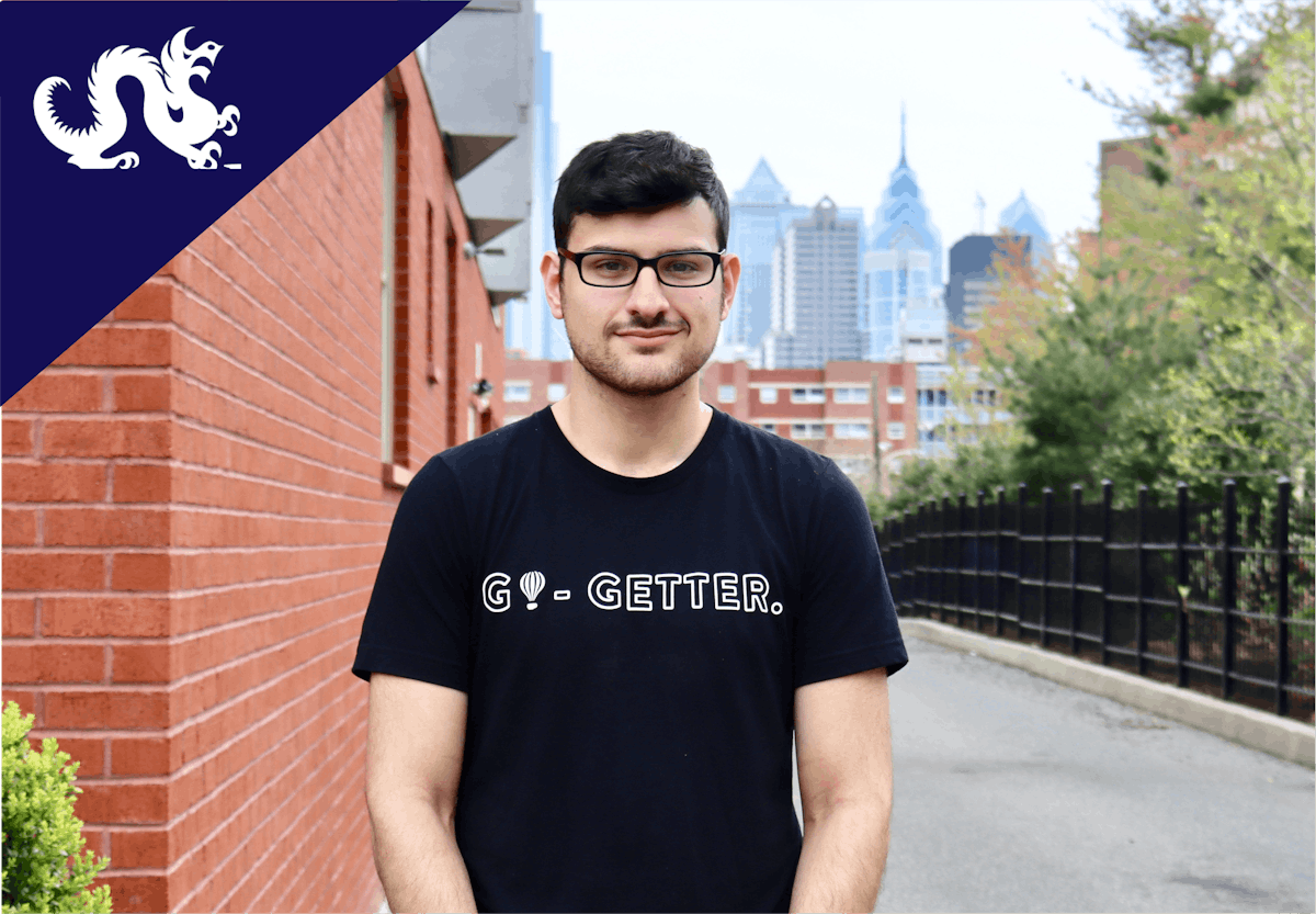 a man standing in front of a brick building