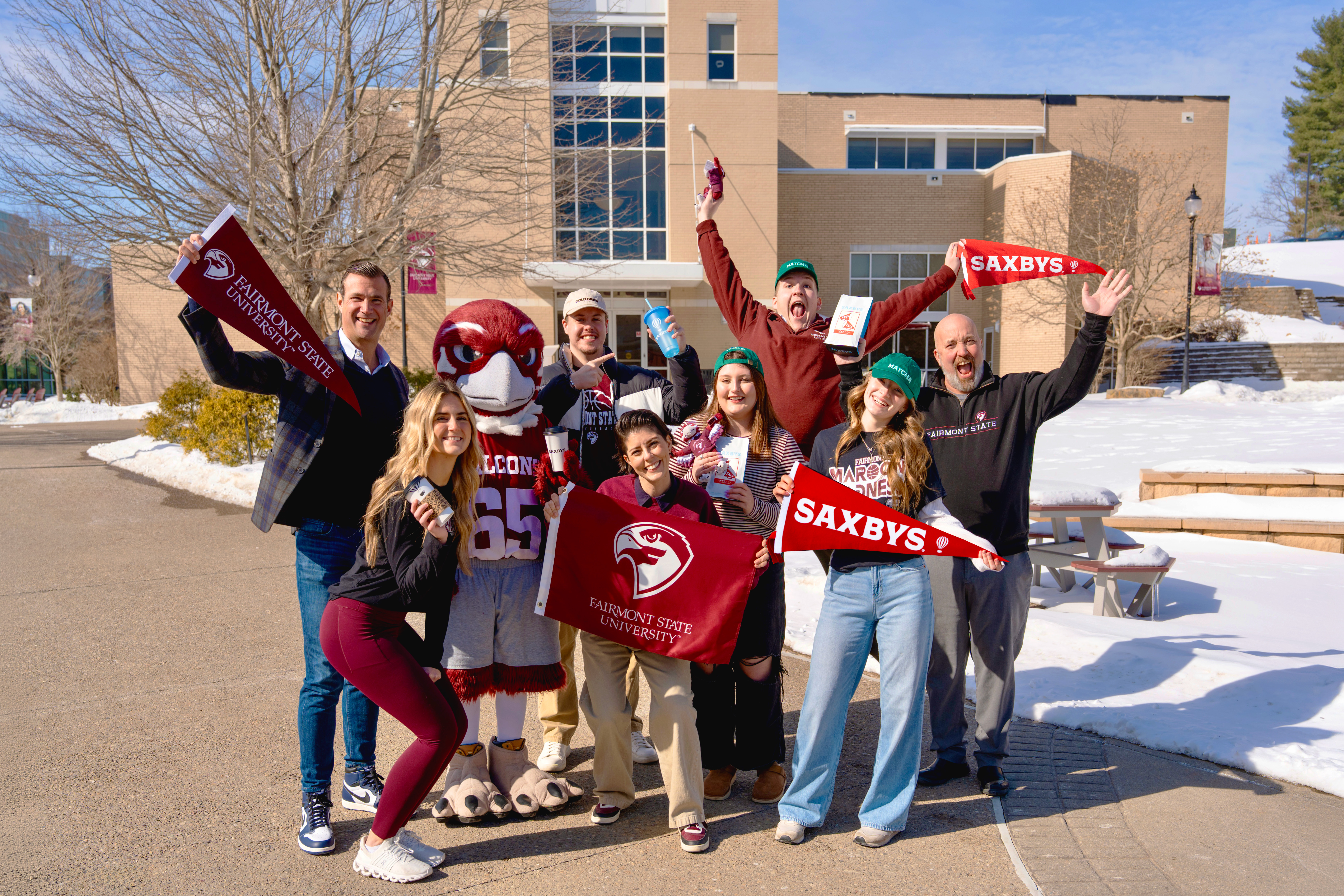 group of students happy with signs