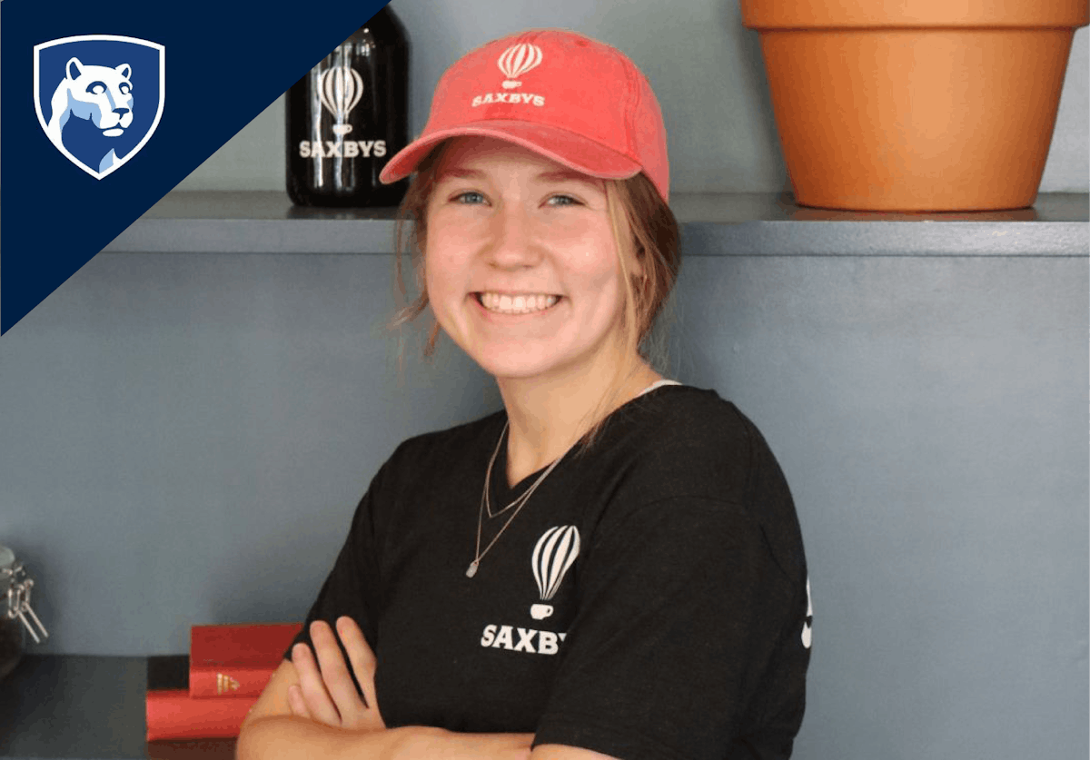 a person wearing a hat and smiling to the camera