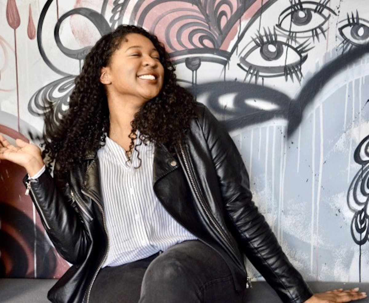 a woman sitting posing for a picture