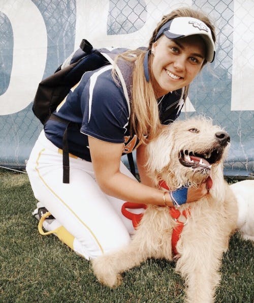 a woman posing with her dog for the camera