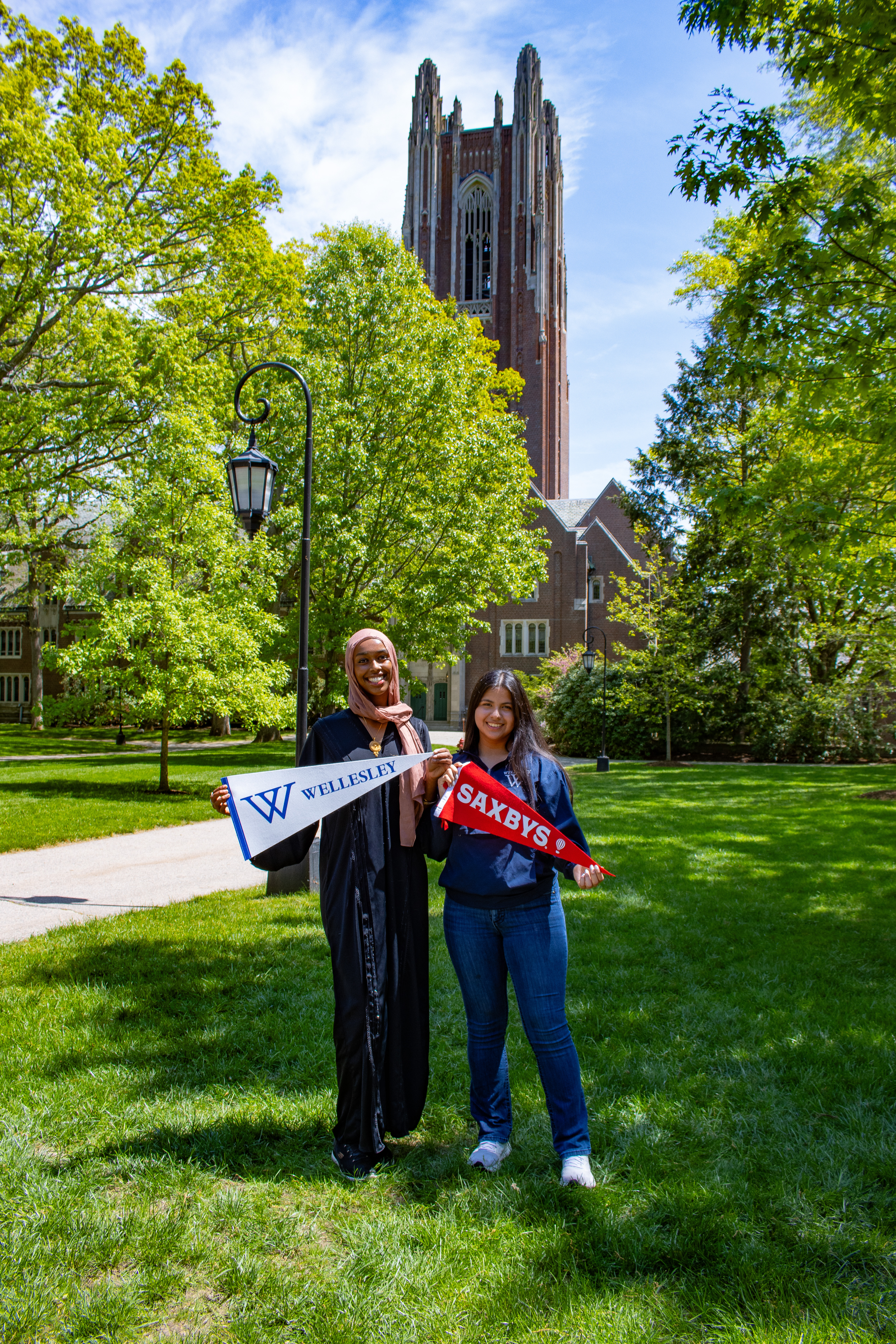 two students holding flags