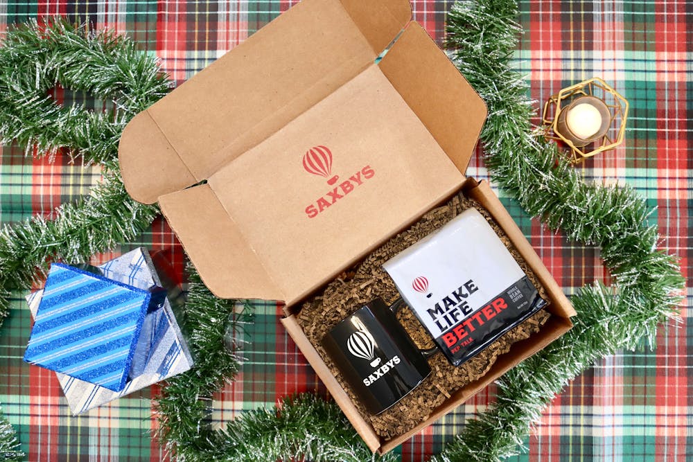 a box with a coffee bag and a black mug