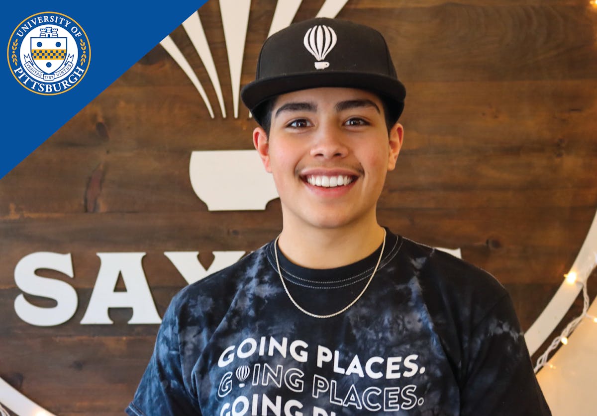 a boy with a hat smiling at the camera
