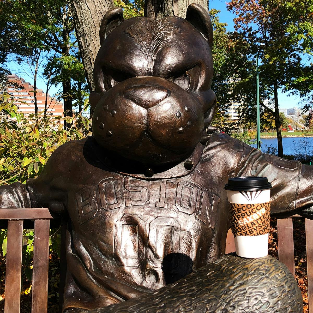 a statue of a terrier sitting on a bench