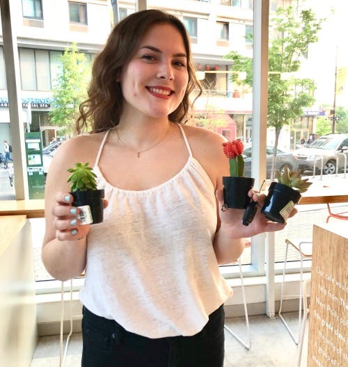 a woman holding plants