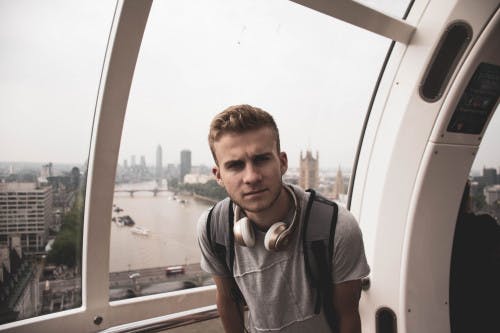 a man standing in front of a car