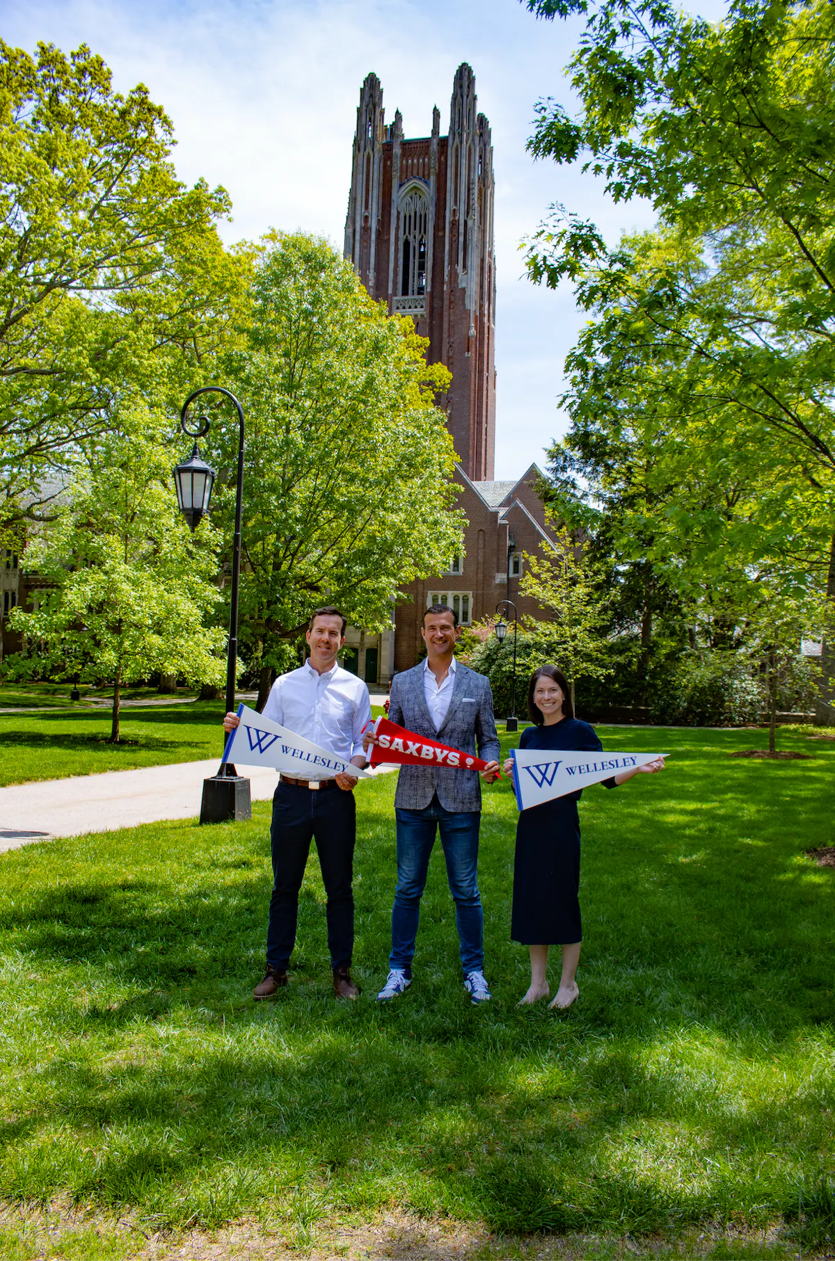 three people holding flags