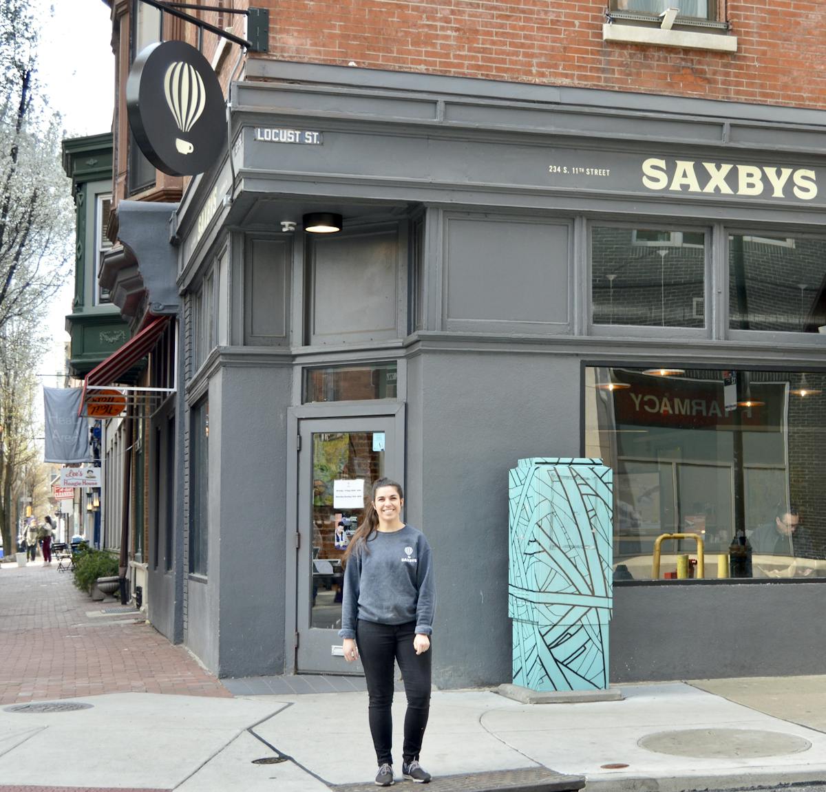 a person walking down a street in front of a building
