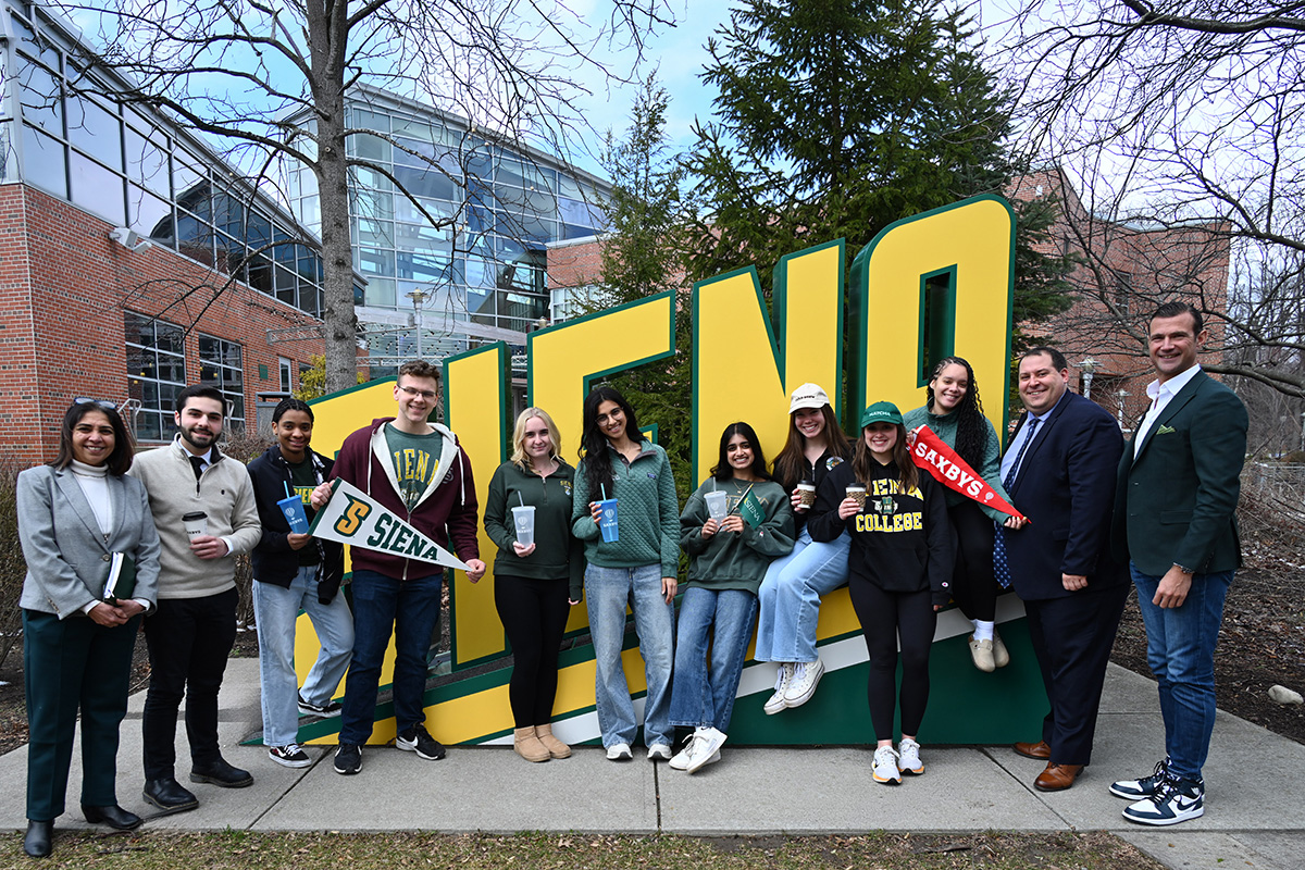 group of students infront of sign