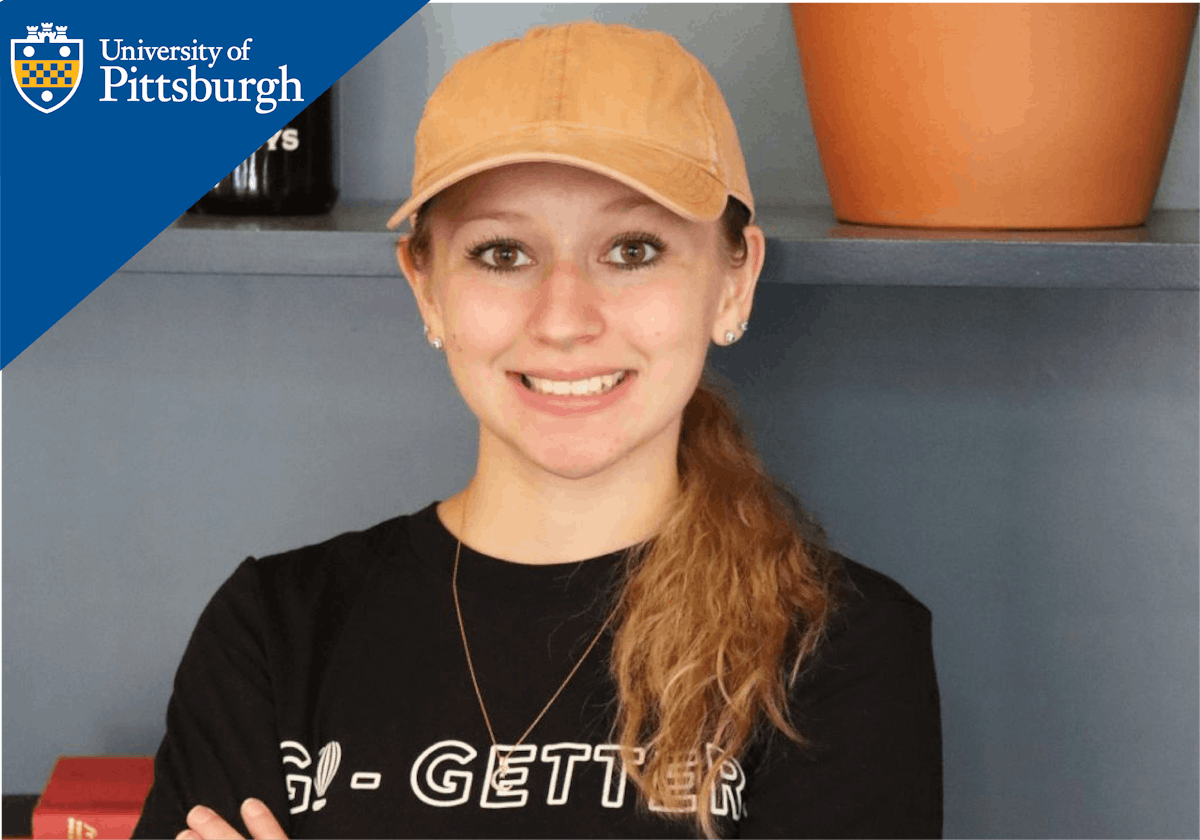 a person wearing a hat and smiling at the camera