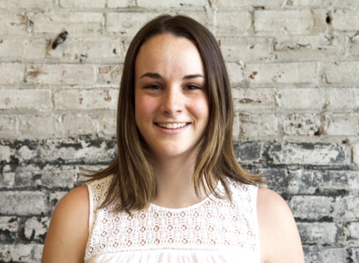 Maddie Dierolf standing in front of a brick wall