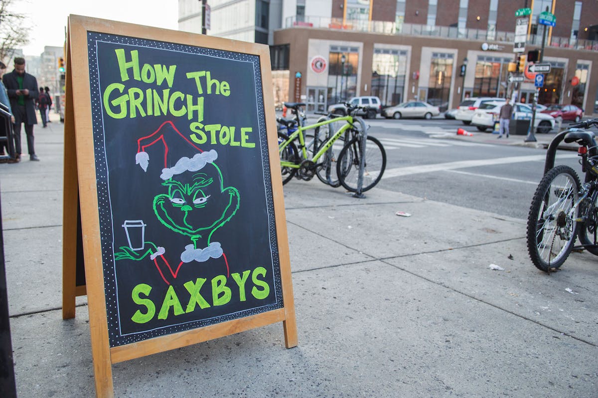 a sign on a sidewalk next to a bicycle