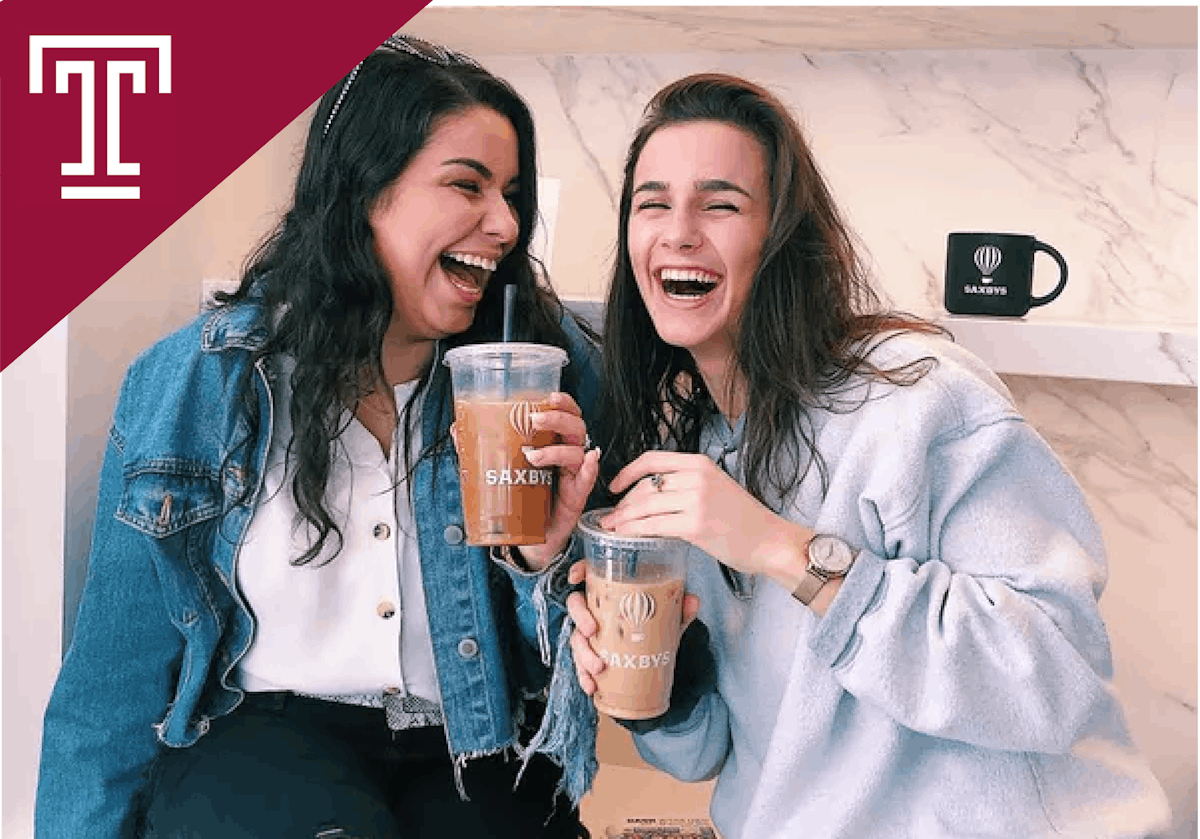 two women holding cups of cold brew