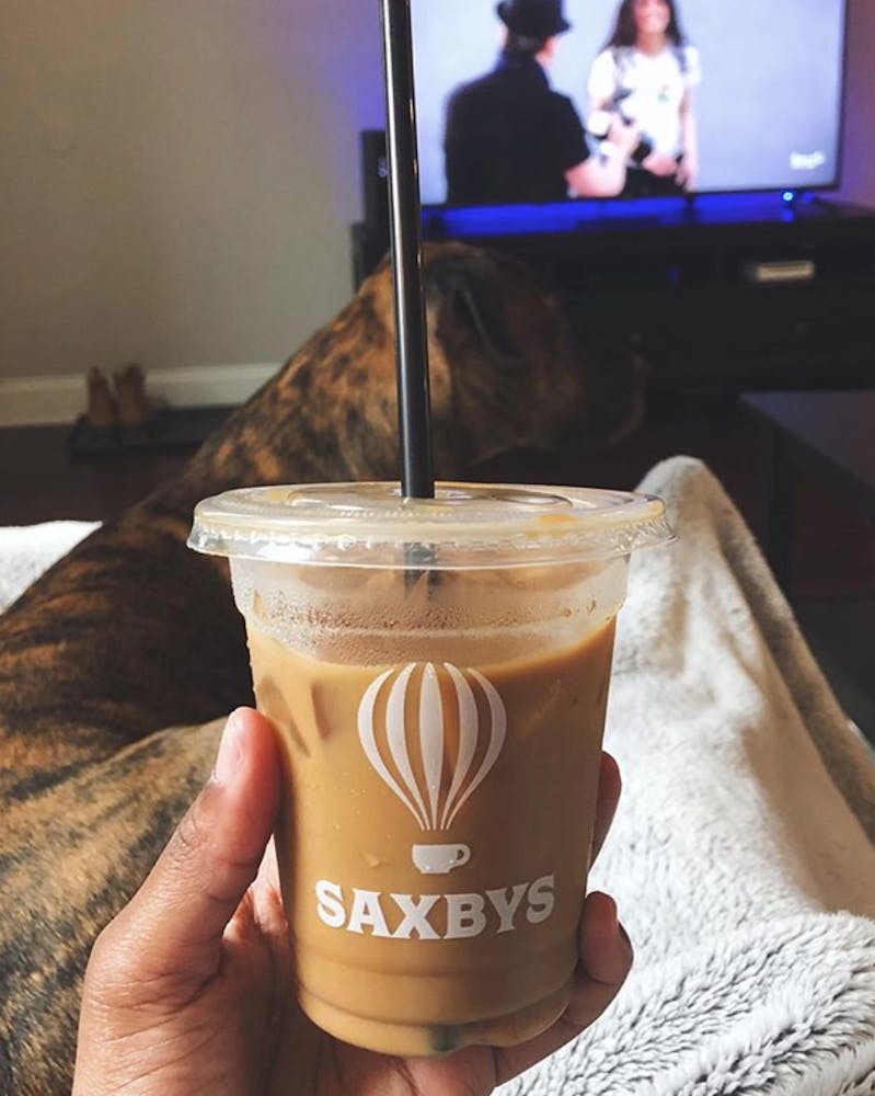a person holding a cup of coffee