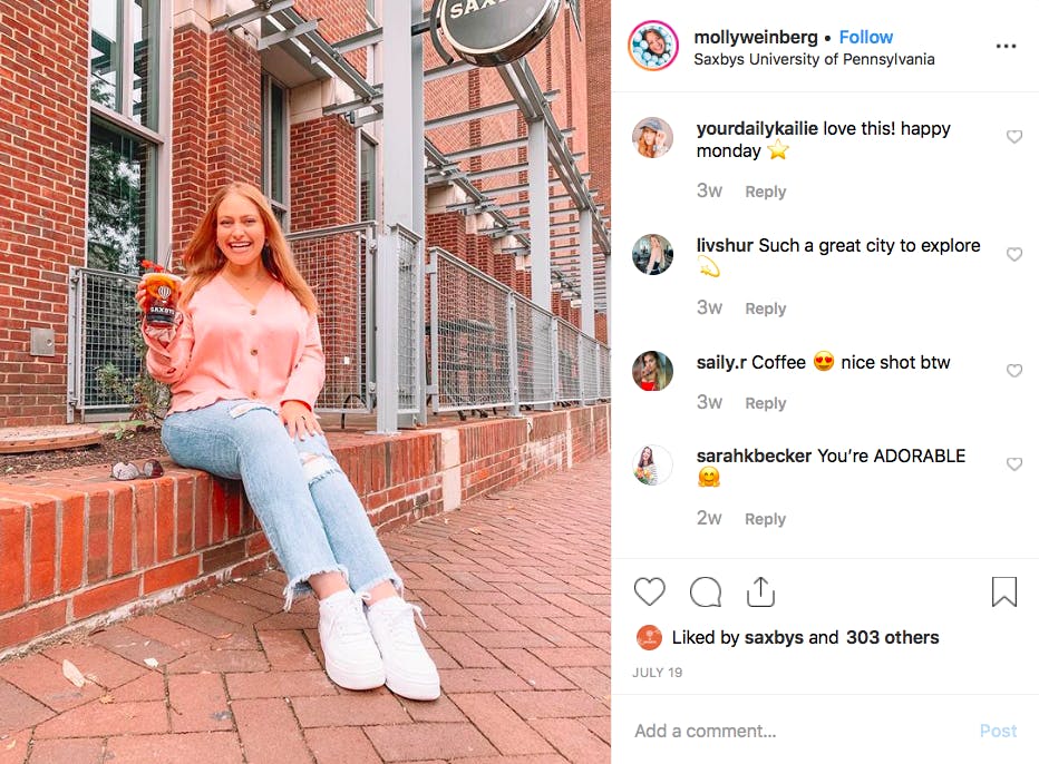 a person sitting in front of a brick building