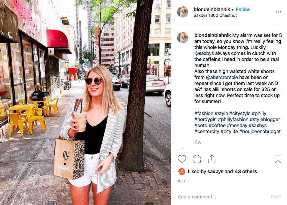 a woman standing on a sidewalk