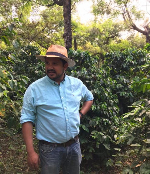 a man standing next to a tree