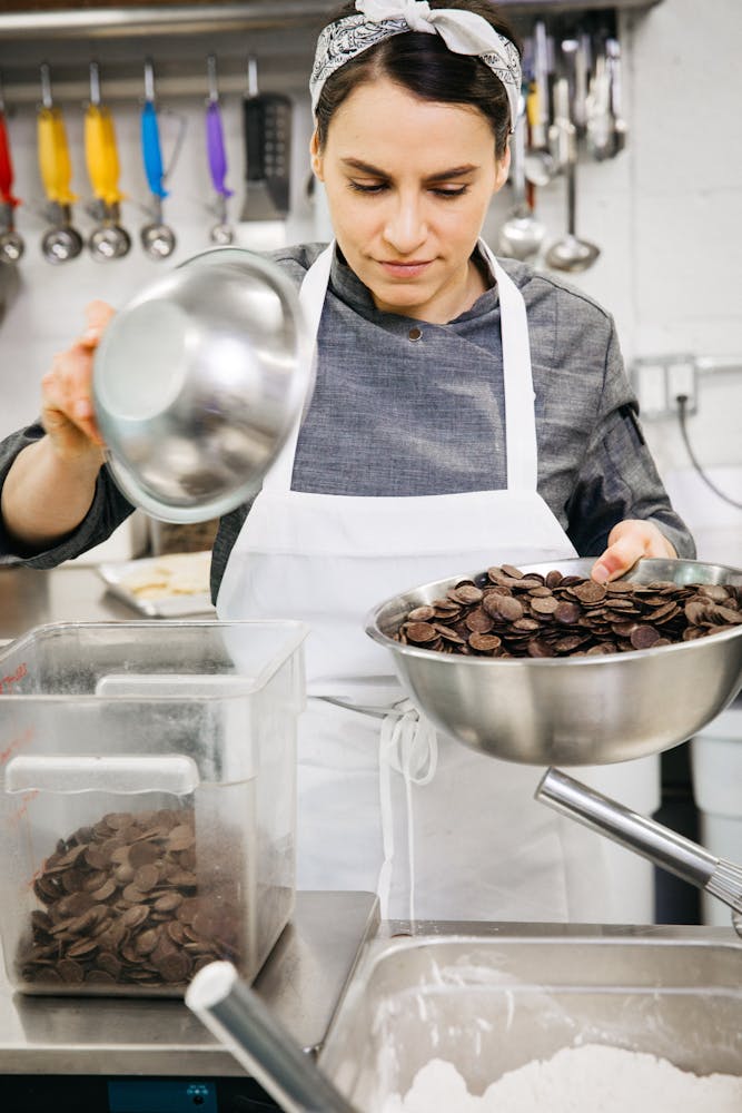 a woman standing in front of a tray of food