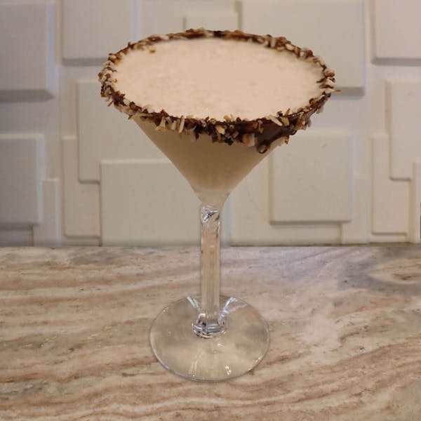 Chocolate Liqueur, Frangelico, Malibu Rum, Dr. McGillicuddy’s Vanilla, and Cream. Garnished with A Toasted Coconut Rim