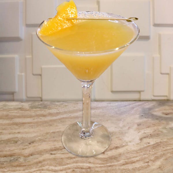 Deep Eddy Peach Vodka, Malibu Rum, Pineapple, and Orange Juice. Garnished With a Peach Slice