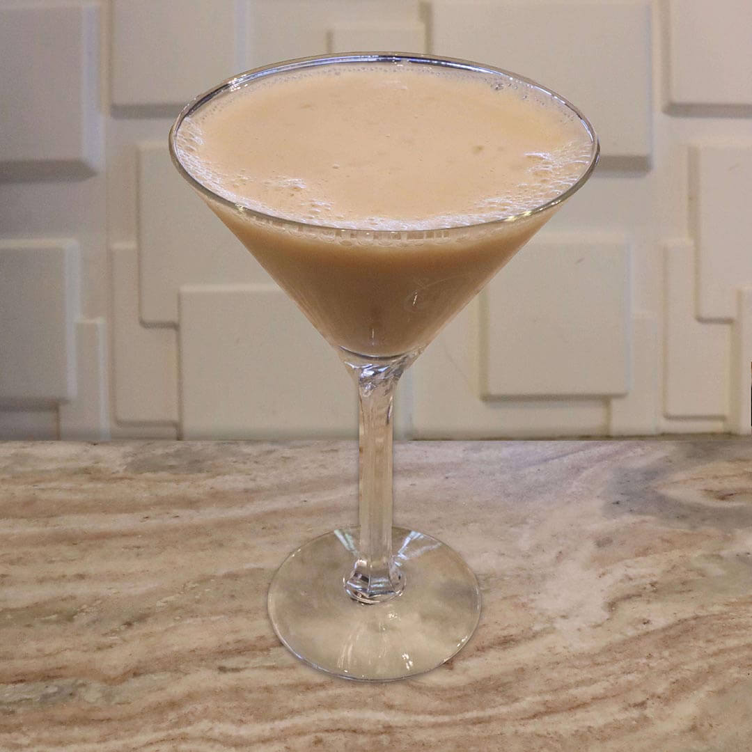 A creamy, golden-tan peanut butter cocktail served in a chilled glass.
