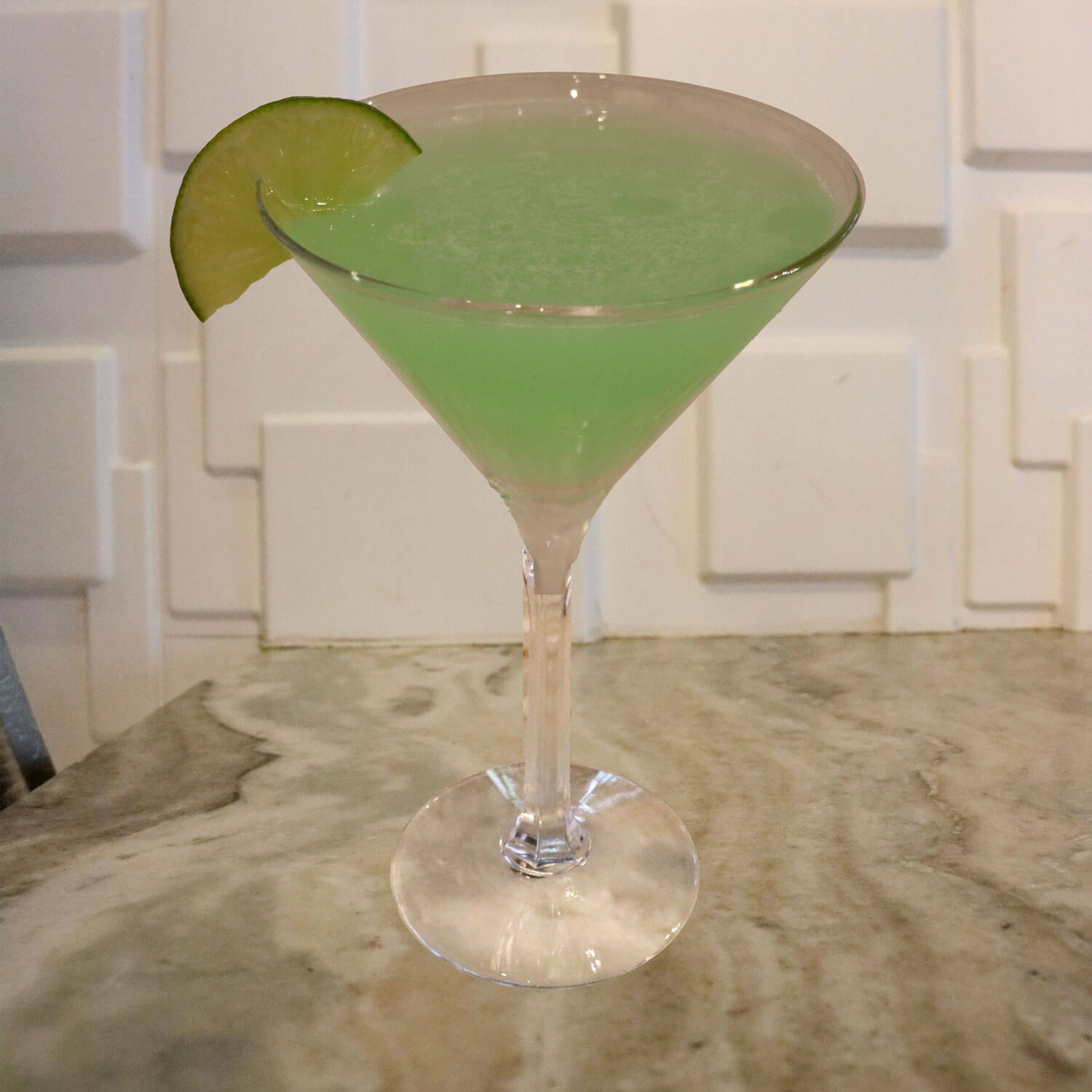 Hpnotiq, Deep Eddy Orange, and Lime Juice. Garnished With a Lime Slice