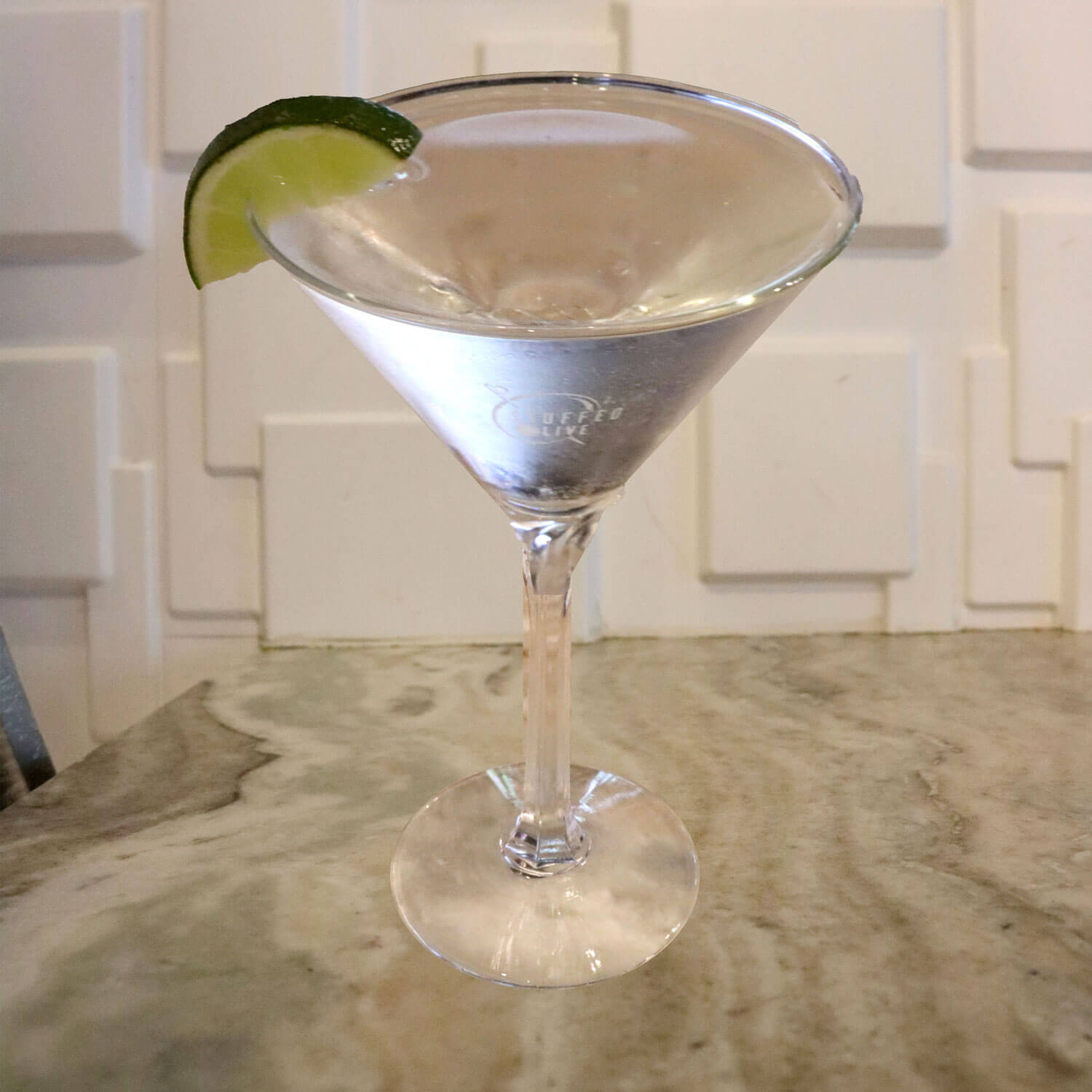 Premium Gin, Fresh Lime Juice, and Simple Syrup. Garnished With a Lime Slice