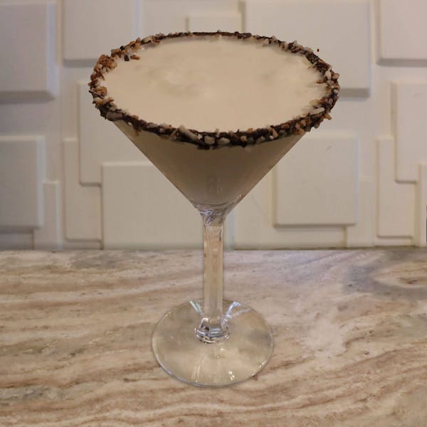 Malibu Rum, White Chocolate Liqueur, Dr. McGillicuddy’s Vanilla, Splash of Cream. Garnished with A Toasted Coconut Rim