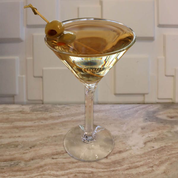 Premium Gin or Vodka, Sweet Vermouth and Dry Vermouth. Garnished with a lemon twist or your choice of stuffed olives