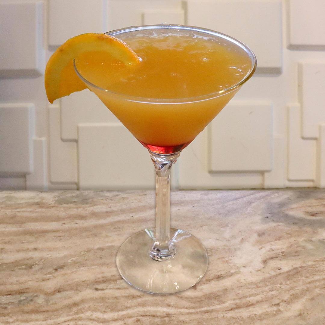 An orange-to-red gradient cocktail reminiscent of a sunset, garnished with an orange slice.