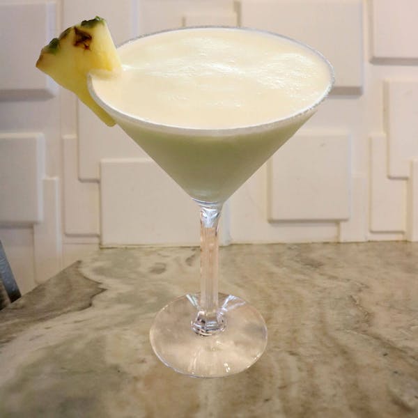 Malibu Rum, Melon Liqueur, Crème De Banana, Pineapple Juice, and Cream. Garnished With a Pineapple Slice