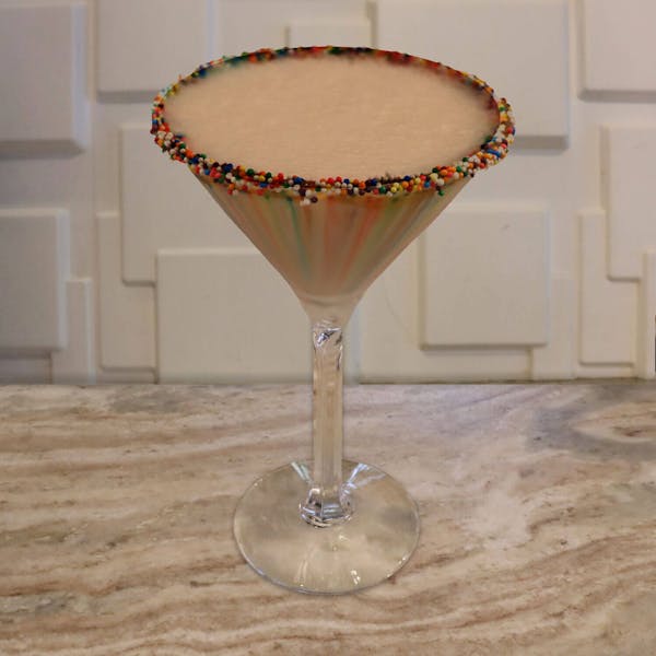 Cake Vodka, Chocolate Liqueur, Creme De Cacao, Chocolate Syrup, and Cream. Garnished with A Rainbow Sprinkle Rim