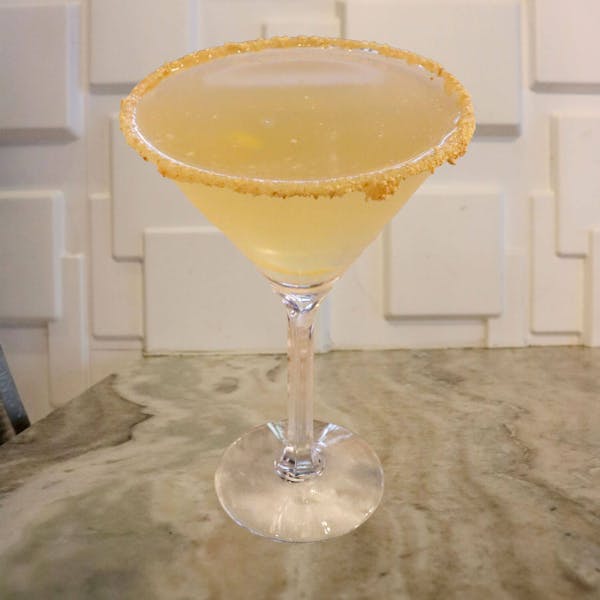 Wild Turkey American Honey Bourbon, Bärenjäger Honey Liqueur, Simple Syrup, Lemon Juice. Garnished With a Lemon Twist, Caramel, and Graham Cracker Rim