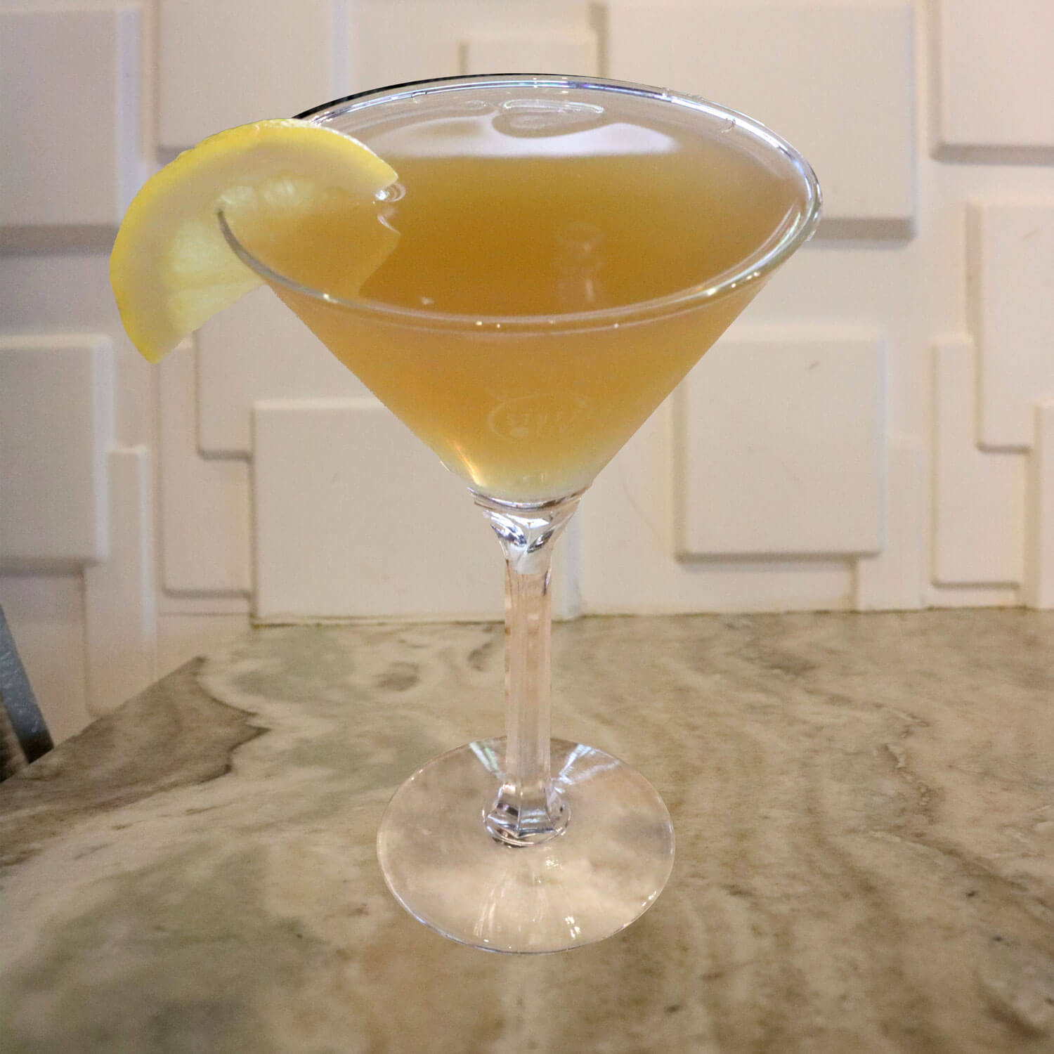 Jameson, Peach Schnapps, Splash of Sour, and Lemonade. Garnished With a Lemon Slice