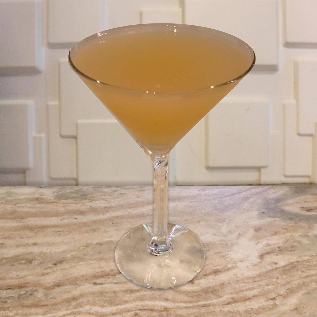 A clear, pale golden-yellow cocktail.